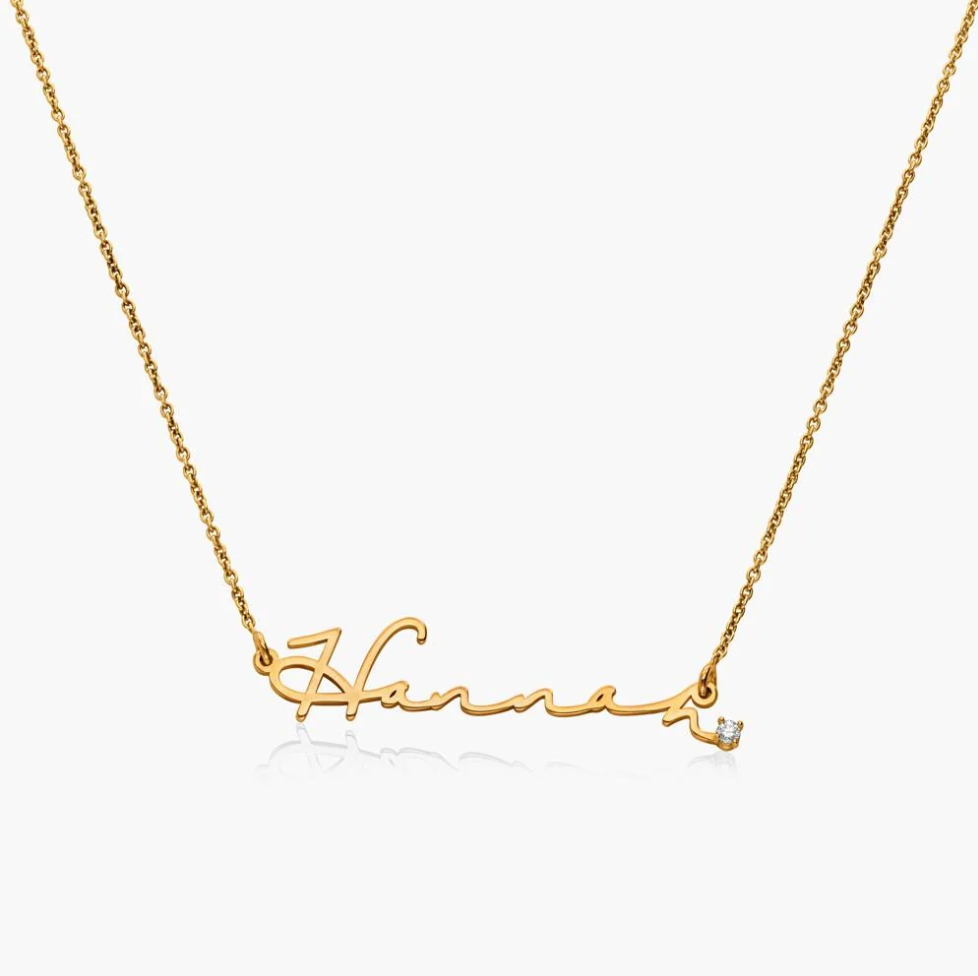 A gold name plate necklace spelling 'Harper' in cursive script, with a small clear gemstone accent at the end. engraved. Diamond, sterling silver 925, gold plated, rose gold plated. makana jewellery, jewelry