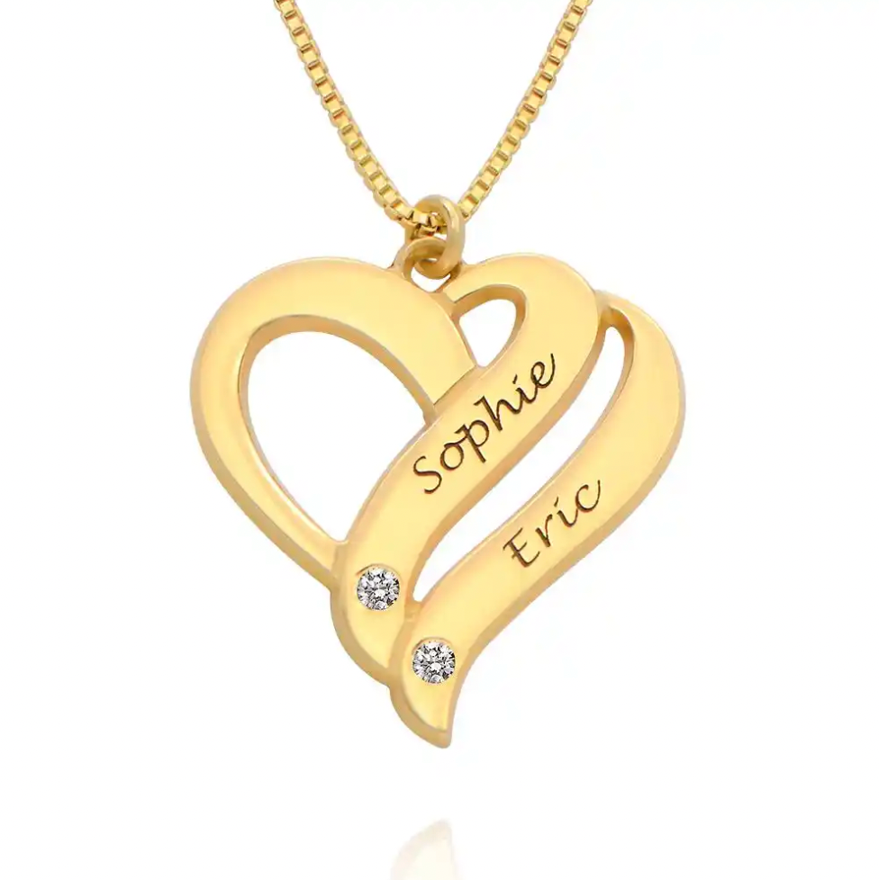 A gold heart-shaped pendant necklace with interlocking curved arms, engraved. Diamond, sterling silver 925, gold plated, rose gold plated. makana jewellery, jewelry