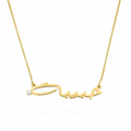 A gold nameplate necklace featuring a cursive script pendant with a small clear gemstone accent on the left side, suspended from a delicate gold chain. Diamond, sterling silver 925, gold plated, rose gold plated. makana jewellery, jewelry.