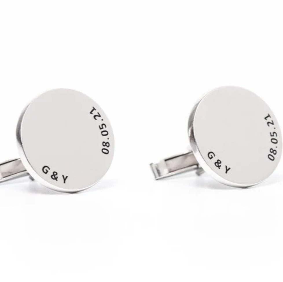 A pair of round silver cufflinks engraved with the initials and the date. Rose gold, sterling silver, plated, makana jewelry, jewellery. gold 
