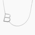 Silver necklace with a letter pendant on a white background. Rose gold, sterling silver, plated, makana jewelry, jewellery. gold